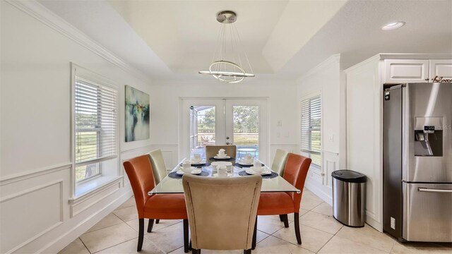 2377 Victoria Dr, Davenport, FL 33837 - dining room featuring french doors, a decorative wall, crown molding, a chandelier, and light tile patterned floors