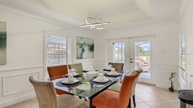 2377 Victoria Dr, Davenport, FL 33837 - dining space featuring a decorative wall, french doors, light tile patterned flooring, a chandelier, and a raised ceiling