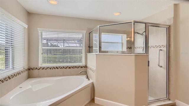 2377 Victoria Dr, Davenport, FL 33837 - bathroom with a garden tub, a shower stall, and recessed lighting