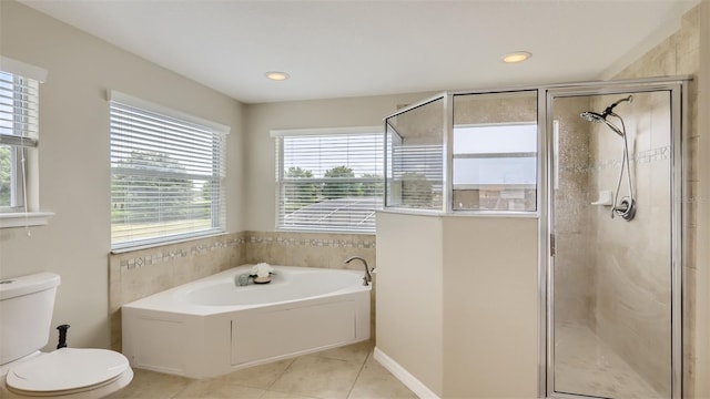 2377 Victoria Dr, Davenport, FL 33837 - bathroom featuring healthy amount of natural light, tile patterned flooring, a bath, a shower stall, and recessed lighting