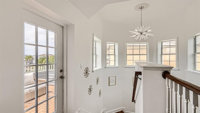 2377 Victoria Dr, Davenport, FL 33837 - stairs featuring a chandelier and vaulted ceiling