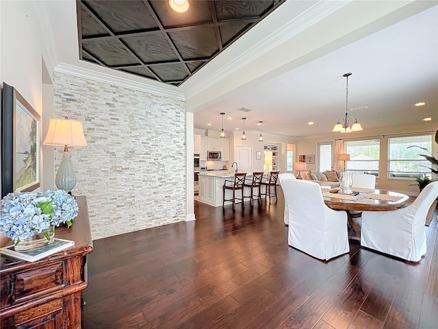 dining area featuring crown molding, a chandelier, and dark hardwood / wood-style floors