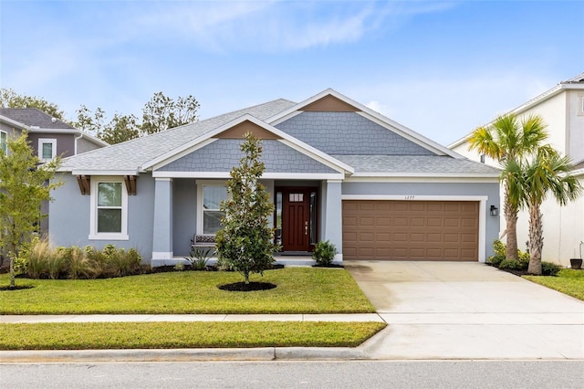 view of front of house featuring a garage and a front yard