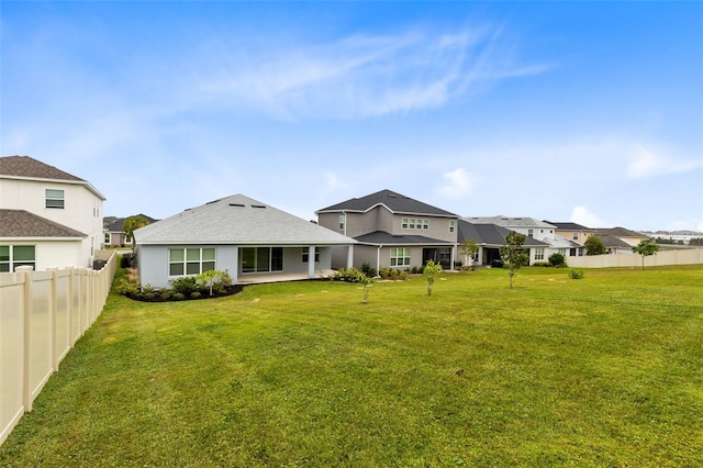 rear view of property with a yard