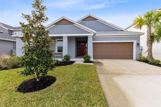 view of front of house with a front yard and a garage