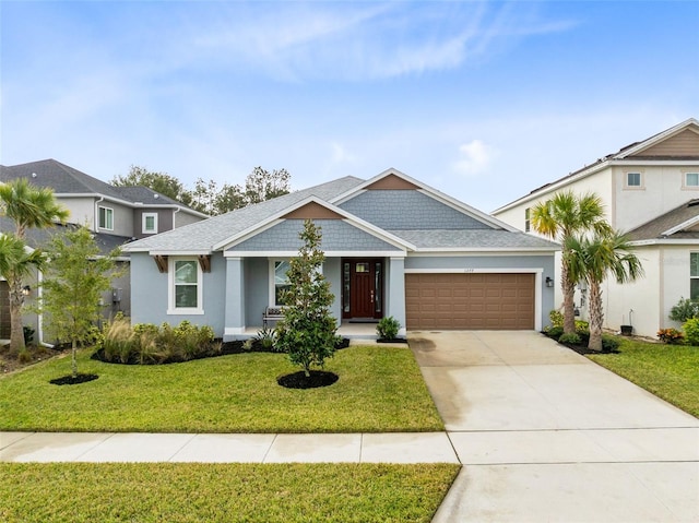 view of front of property with a front lawn and a garage