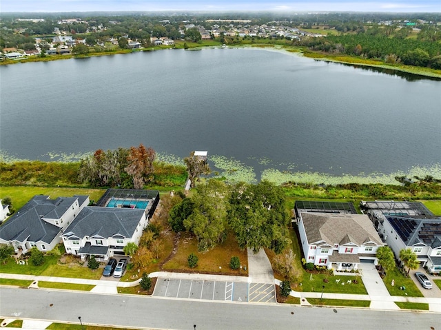 birds eye view of property with a water view