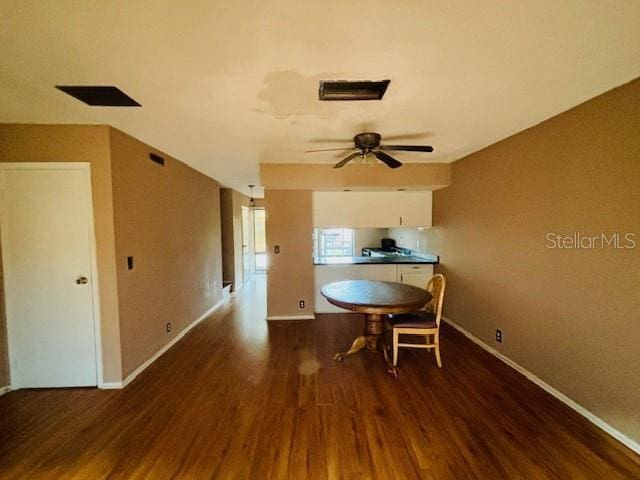 dining space featuring ceiling fan and dark wood-type flooring