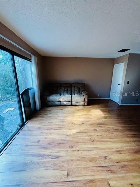 interior space featuring a textured ceiling and light wood-type flooring