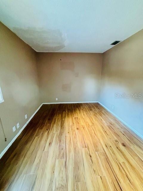 empty room with hardwood / wood-style flooring