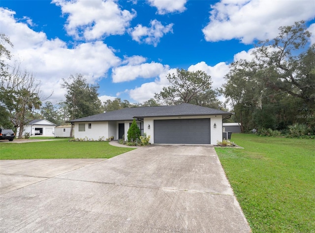 single story home featuring a front lawn and a garage