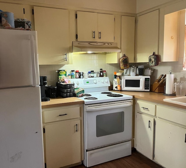 kitchen featuring white appliances, backsplash, white cabinets, sink, and dark hardwood / wood-style flooring