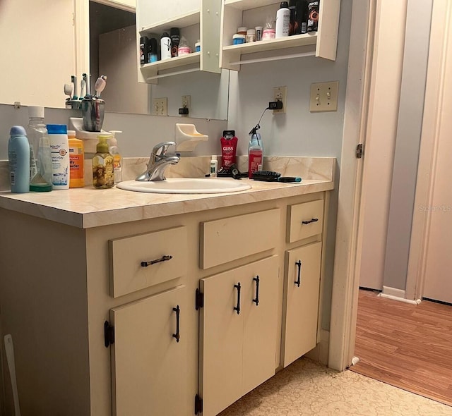 interior space with sink, white cabinets, and light hardwood / wood-style floors