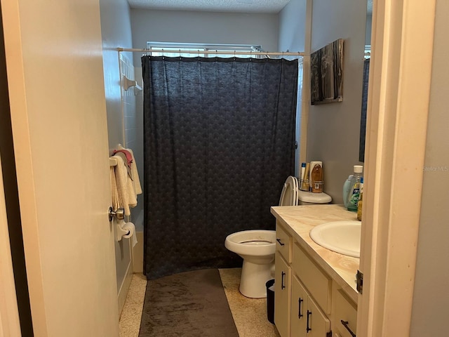 bathroom with vanity, toilet, a textured ceiling, and walk in shower