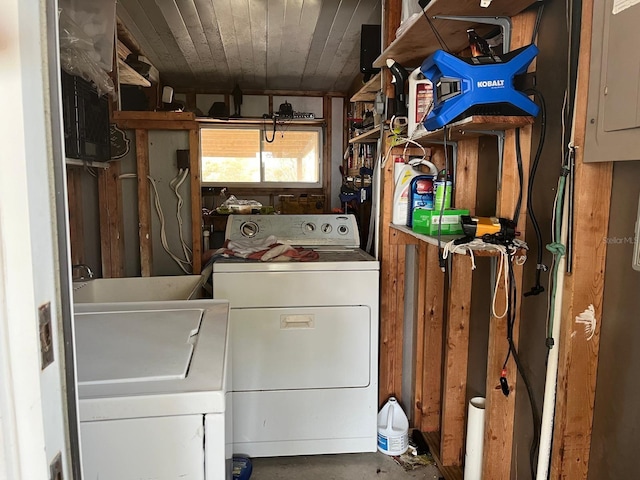 clothes washing area with washer and dryer, sink, and electric panel