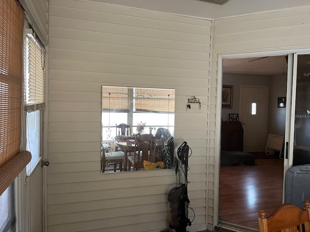 interior space with wood walls and dark hardwood / wood-style flooring