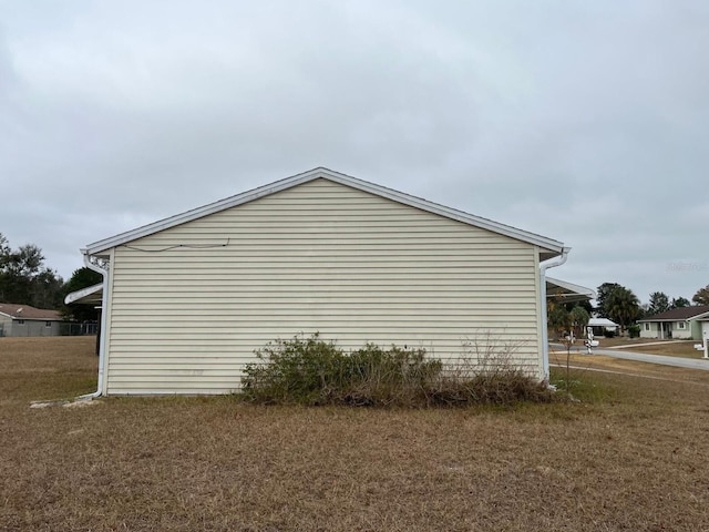 view of side of property featuring a yard