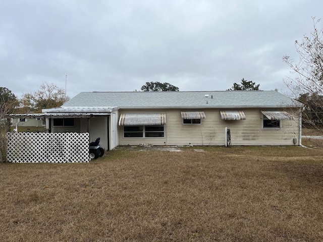 back of house featuring a yard