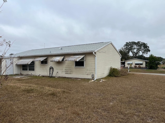 back of house with a yard