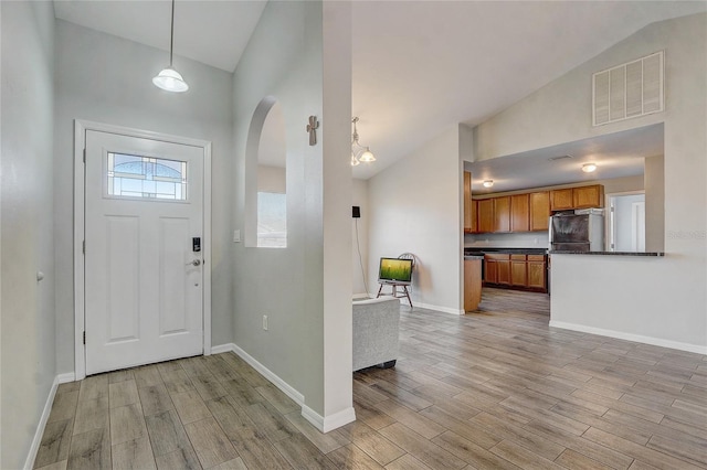 foyer with high vaulted ceiling