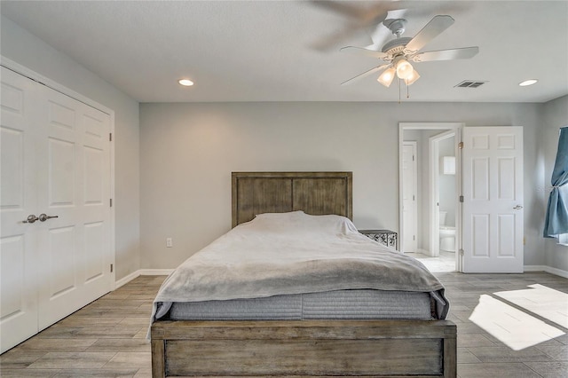 bedroom with ceiling fan, ensuite bathroom, and a closet