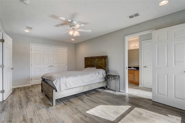 bedroom featuring ensuite bath, ceiling fan, and a closet