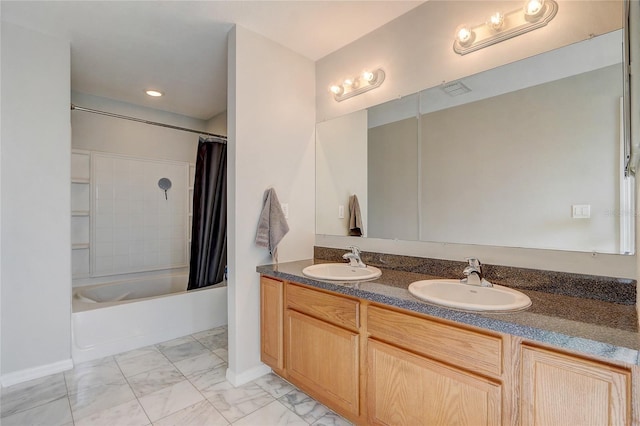 bathroom featuring shower / tub combo and vanity