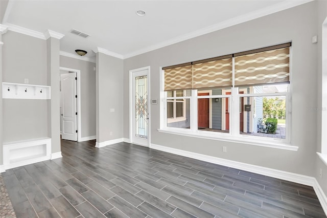 empty room featuring dark hardwood / wood-style flooring and ornamental molding