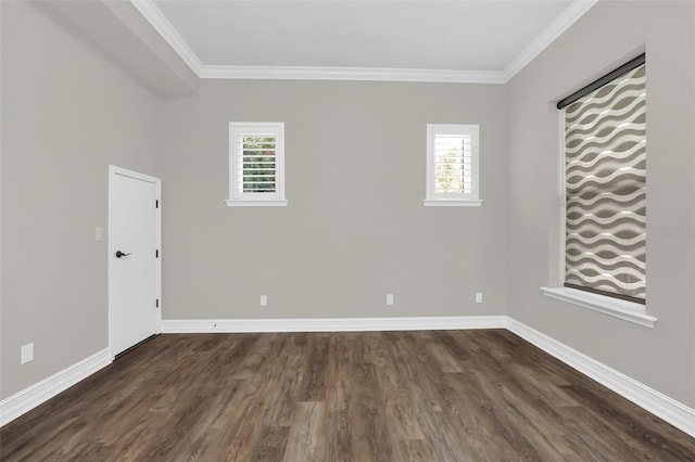 spare room with dark hardwood / wood-style floors, crown molding, and a healthy amount of sunlight