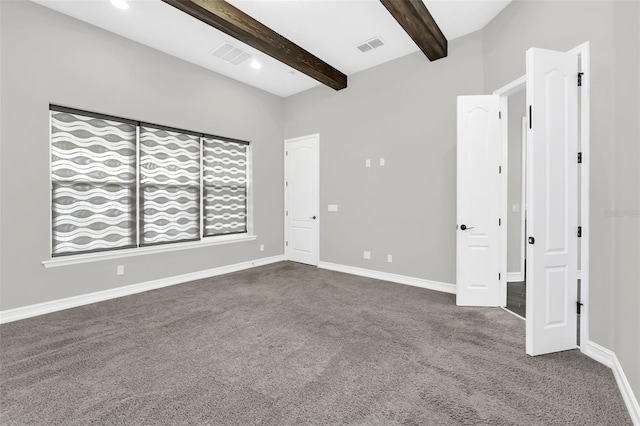 unfurnished room featuring carpet floors and beamed ceiling