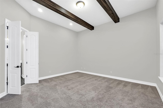 carpeted empty room with vaulted ceiling with beams