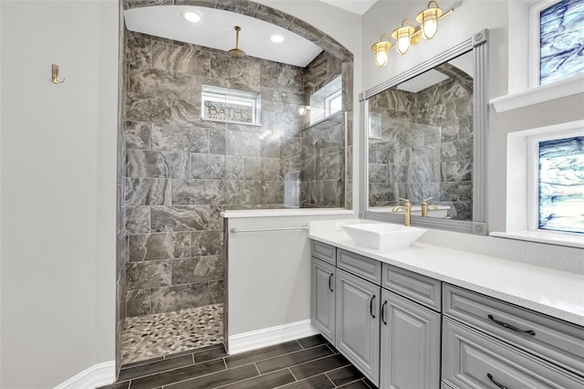 bathroom with plenty of natural light, vanity, and tiled shower