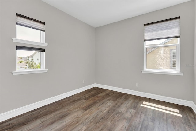 spare room with dark hardwood / wood-style flooring