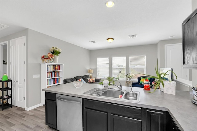 kitchen featuring dishwasher, light hardwood / wood-style floors, and sink