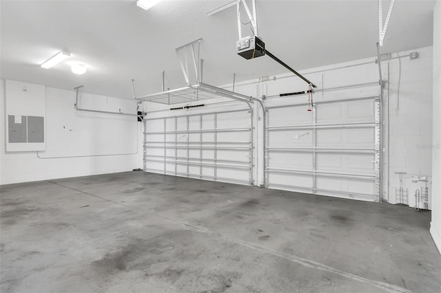 garage with electric panel and a garage door opener