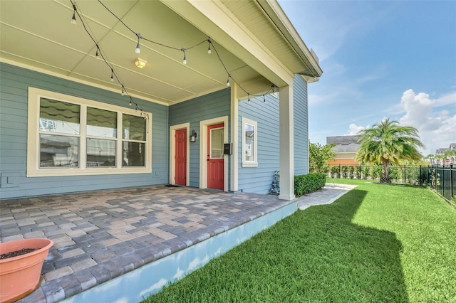 view of exterior entry with a lawn