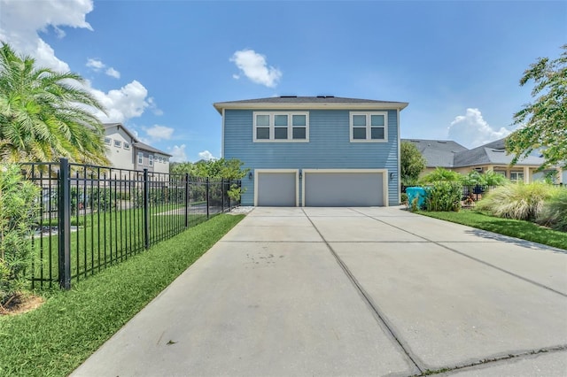 view of front of property with a garage and a front lawn