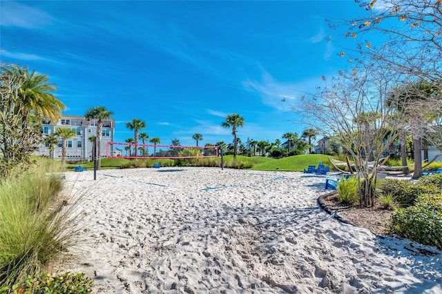 view of community featuring volleyball court and a lawn