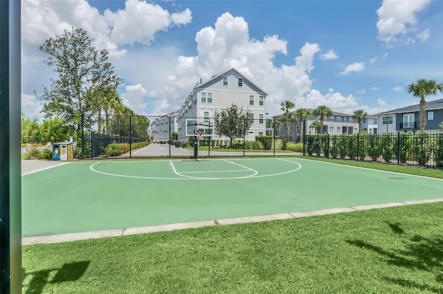 view of sport court featuring a lawn