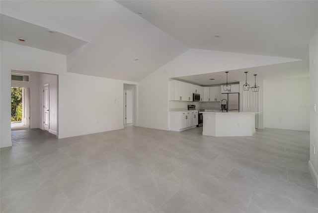 unfurnished living room featuring light tile patterned floors and high vaulted ceiling