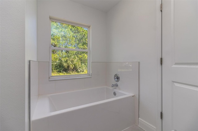 bathroom featuring a bath and a healthy amount of sunlight