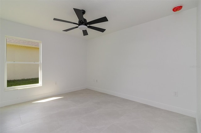 unfurnished room with ceiling fan and light tile patterned floors