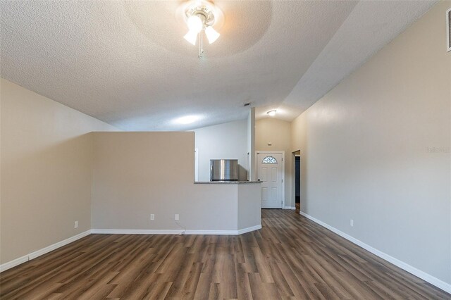 unfurnished living room with a textured ceiling, lofted ceiling, ceiling fan, and dark wood-type flooring