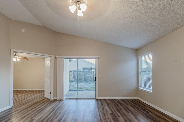 empty room featuring dark hardwood / wood-style floors, plenty of natural light, lofted ceiling, and ceiling fan