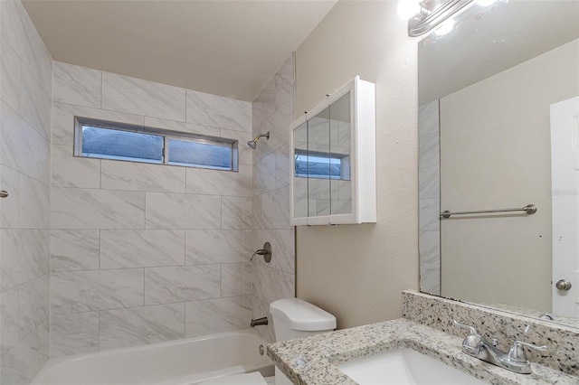 full bathroom featuring toilet, vanity, and tiled shower / bath