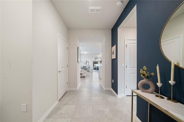 hall with light tile patterned floors