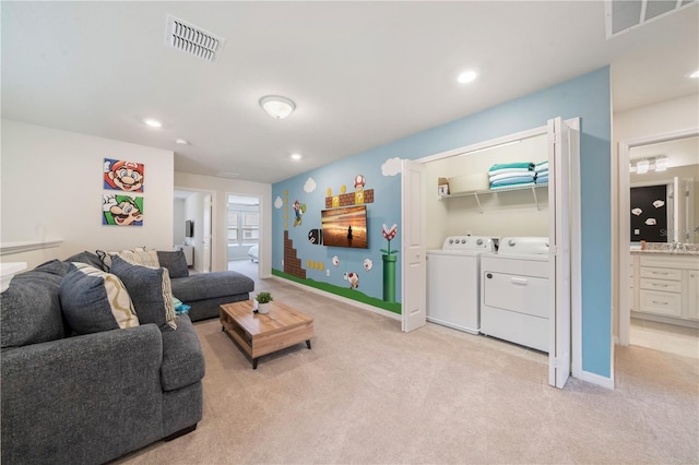 carpeted living room with washer and clothes dryer