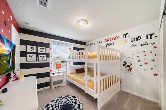 carpeted bedroom featuring a textured ceiling