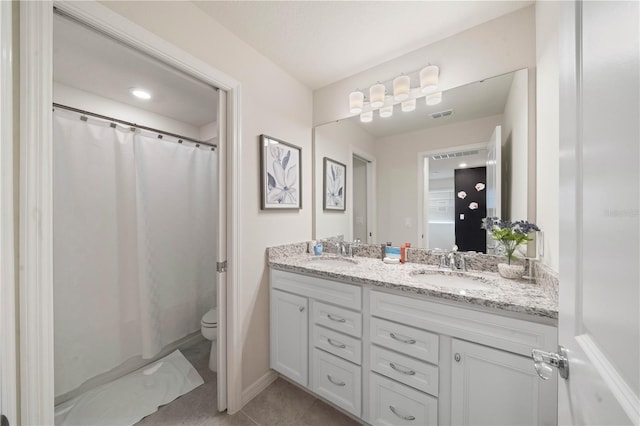 bathroom with tile patterned floors, vanity, and toilet