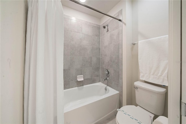 bathroom with toilet and shower / tub combo